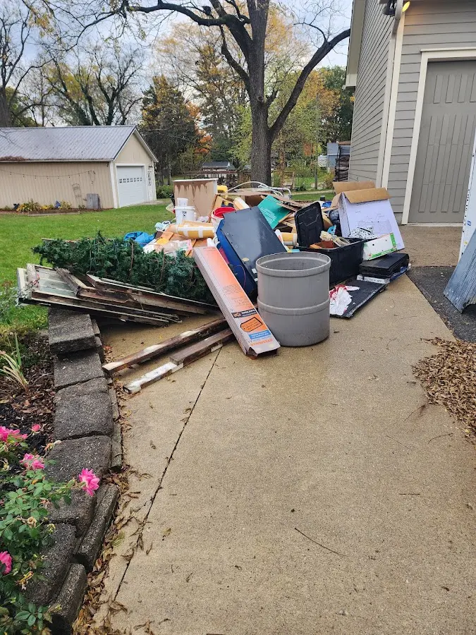 Dumpster being loaded with debris for Estate Cleanout Dumpster Rental in Dennis